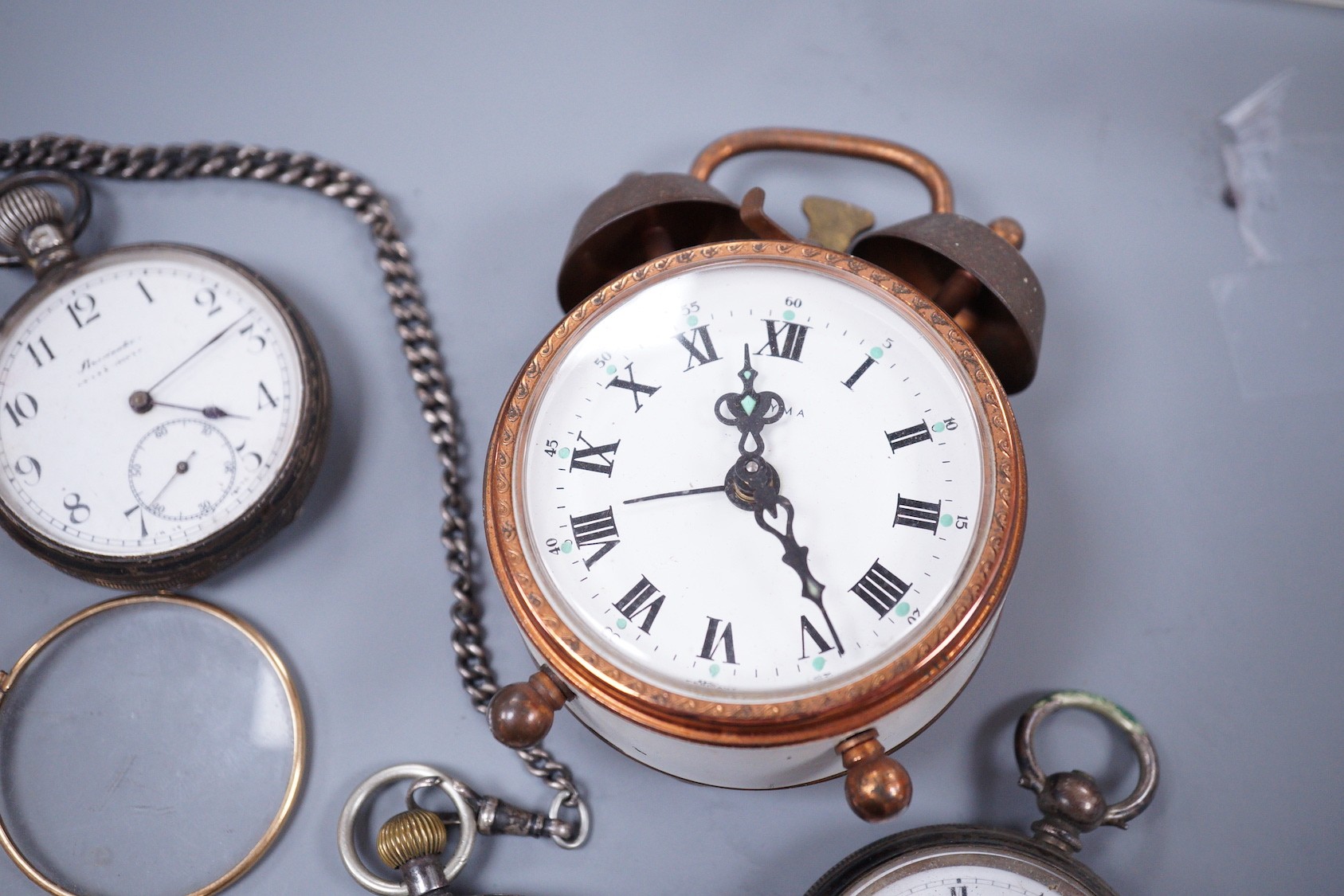 A small collection of six assorted pocket watches, including a silver open face, gun metal on a silver albert and gold plated, a Estyma alarm clock and a pair of gold plated lorgnettes.